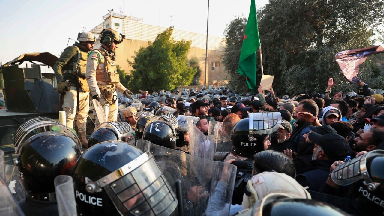 Iraqi riot police prevent protesters from reaching the Swedish embassy in Baghdad on January 23, 2023