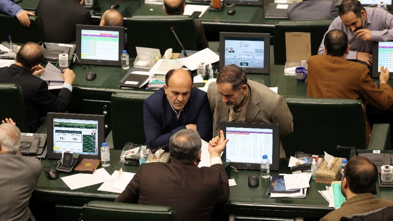 Iranian MPs attend the parliamentary session