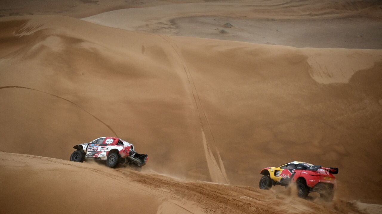 Sebastien Loeb chasing Giniel de Villiers in stage eight. The Frenchman passed the South African Toyota driver in the stage and the overall rankings