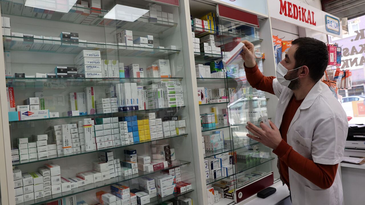 An employee takes a box of medicines on shelves at a pharmacy in the Turkish capital Ankara on December 13, 2021. - Turkeys pharmacists have brought to light the struggle of many patients who need medicines to treat diseases like diabetes and childrens fevers but cannot find them. They say the crisis that has deteriorated because of the fall in the Turkish liras value. (Photo by ADEM ALTAN/AFP via Getty Images)