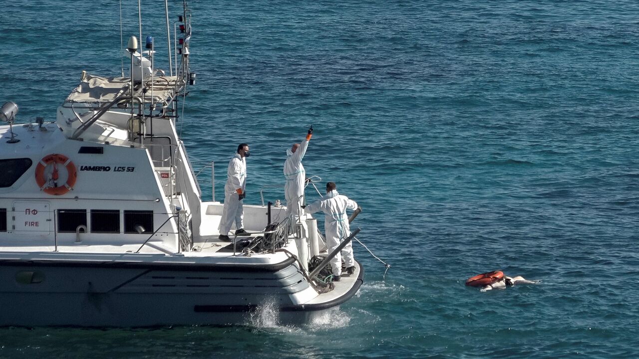 Greek coastguard rescuers recover a body from the sea off the island of Kythira, at the southern end of the Peloponnese Peninsula on October 9, 2022. (Photo by SAVVAS KARMANIOLAS/AFP via Getty Images)