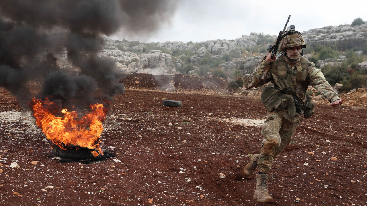 Fighters affiliated with Hayat Tahrir al-Sham take part in a military excercise on attacking tactics with live ammunition, on the outskirts of Idlib, Syria, Nov. 8, 2022.