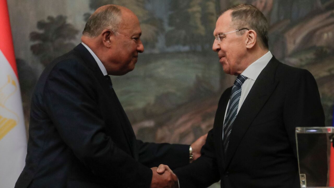 Russian Foreign Minister Sergey Lavrov (R) shakes hands with his Egyptian counterpart, Sameh Shoukry.
