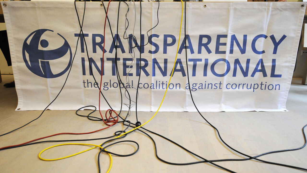 Microphone cables dangle over a logo of Transparency International during a press conference of the release of the Corruption Perceptions Index, Berlin, Germany, Sept. 23, 2008.