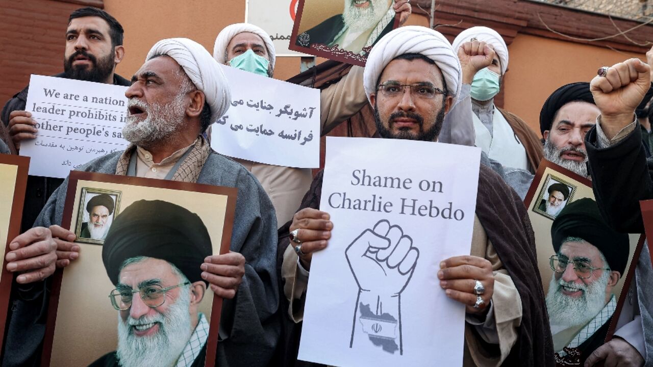 Demonstrators gather with images of Iran's supreme leader Ayatollah Ali Khamenei during a protest against weekly Charlie Hebdo outside the French embassy in Tehran
