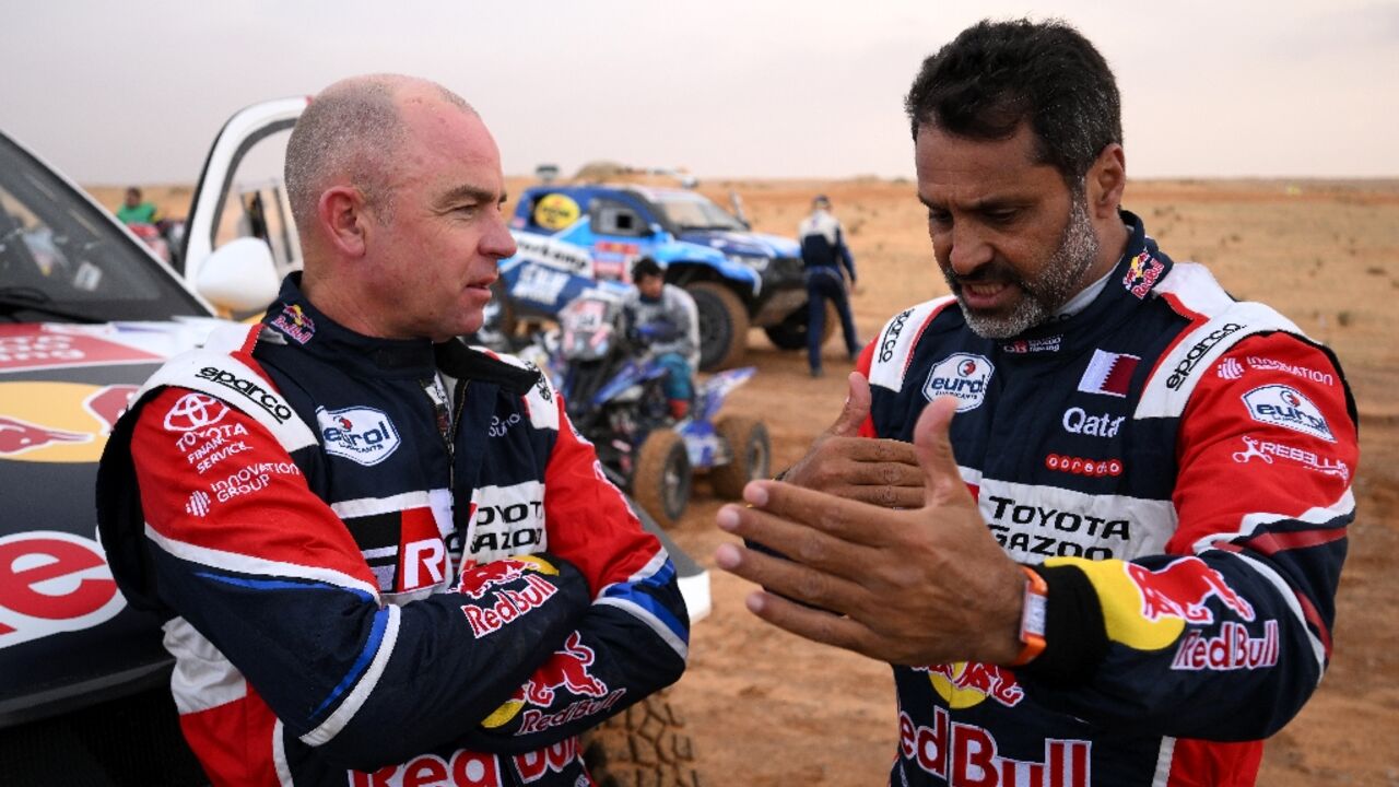 Nasser Al-Attiyah (R), who stops the standings in the cars, with Giniel De Villiers after Tuesday's rain-affected stage