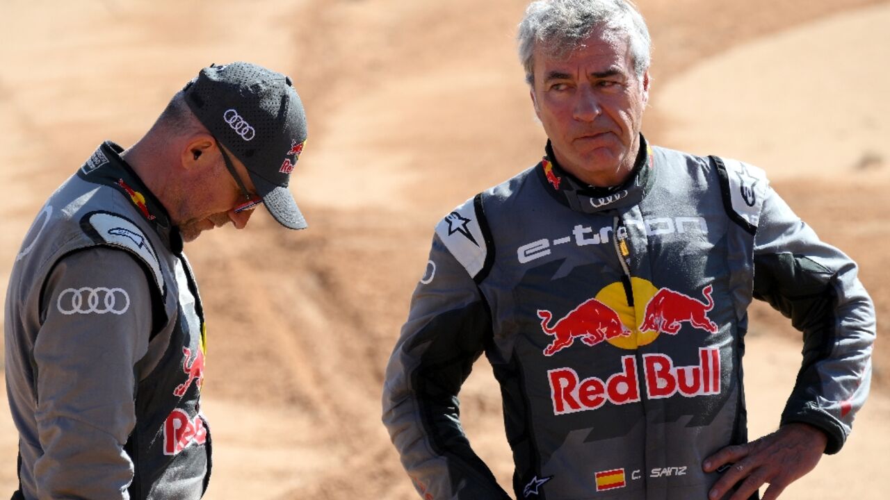 Audi's hybrid drivers Stephane Peterhansel of France (L) and Carlos Sainz of Spain after their respective crashes on stage six