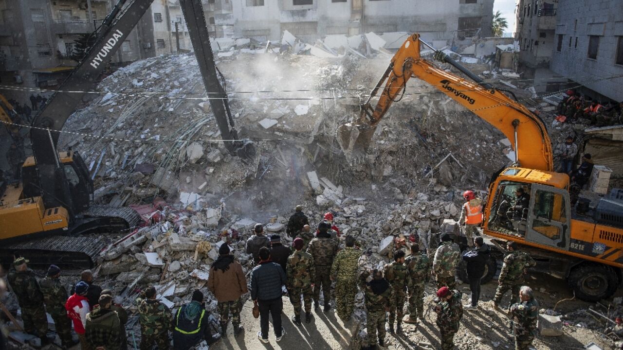 Rescue workers search for survivors in the town of Jableh in northwestern Syria