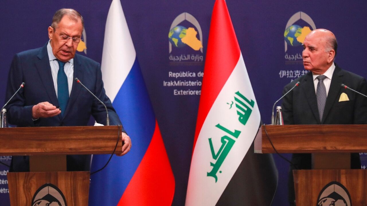Iraqi Foreign Minister Fuad Hussein (R) and his Russian counterpart Sergei Lavrov speak to reporters in Baghdad on February 6, 2023