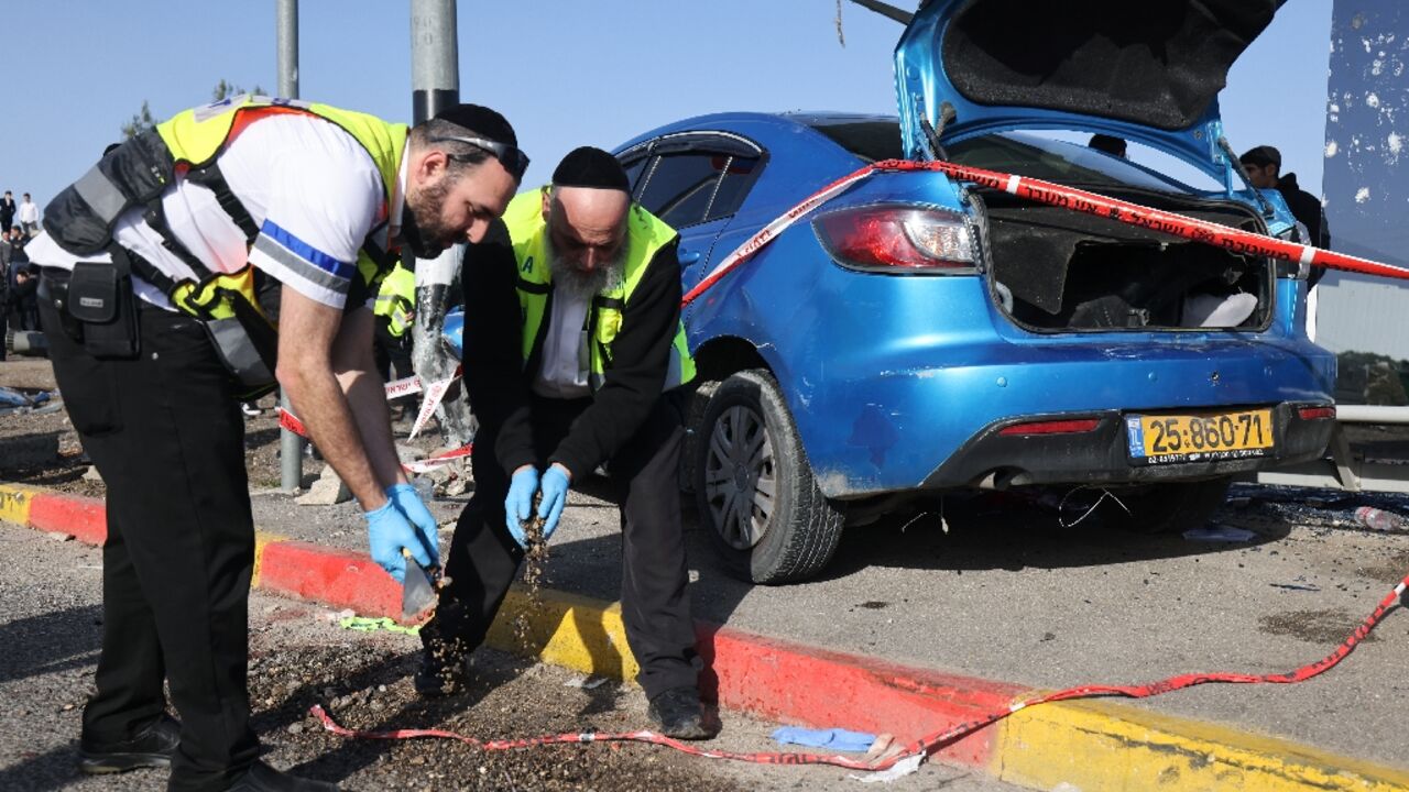 Volunteers from Zaka, an ultra-Orthodox Jewish emergency response team, work at the scene of the ramming attack in east Jerusalem