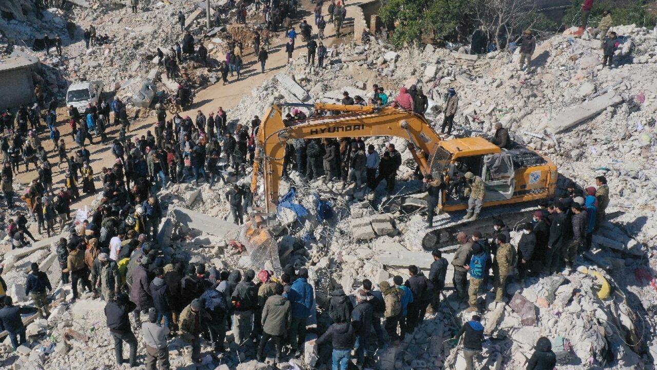 Rescuers search amid the ruins in Syria's rebel-held northwestern Idlib province on February 8, 2023 