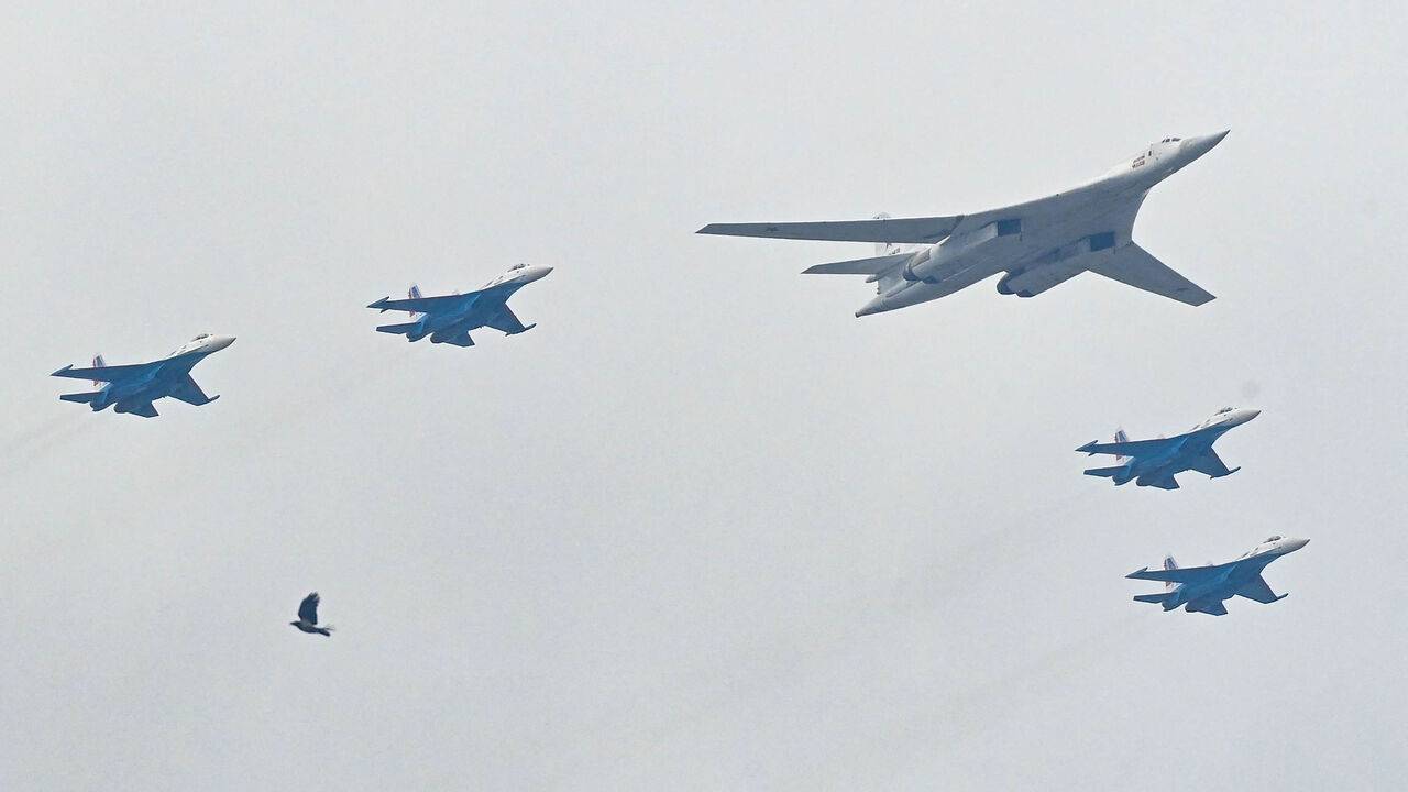 A Russian Tupolev Tu-160 strategic bomber and Su-35S fighter jets fly in formation during the Victory Day military parade, Moscow, Russia, May 9, 2021.