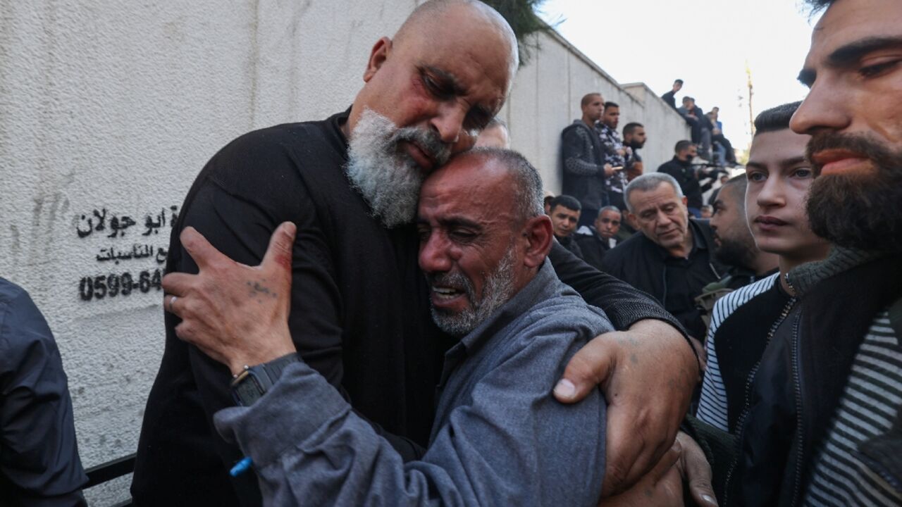 The fathers of Palestinians Nidal Khazim (L) and Youssef Shreem (C) during the funeral of their sons after an Israeli raid on Jenin