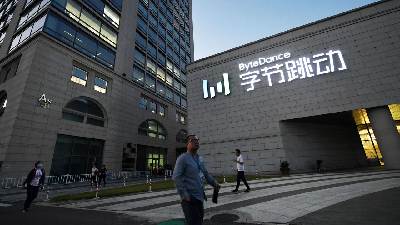 People walk past the headquarters of ByteDance, the parent company of video sharing app TikTok, in Beijing on September 16, 2020. - Silicon Valley tech giant Oracle is "very close" to sealing a deal to become the US partner to Chinese-owned video app TikTok to avert a ban in the United States, President Donald Trump said on September 15.  (Photo by GREG BAKER/AFP via Getty Images)