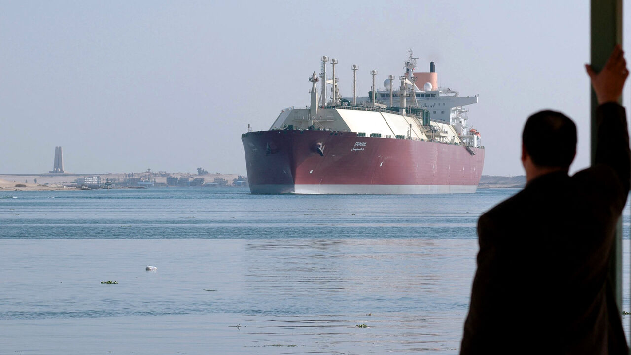 Egyptian man looks at Qatari LNG carrier
