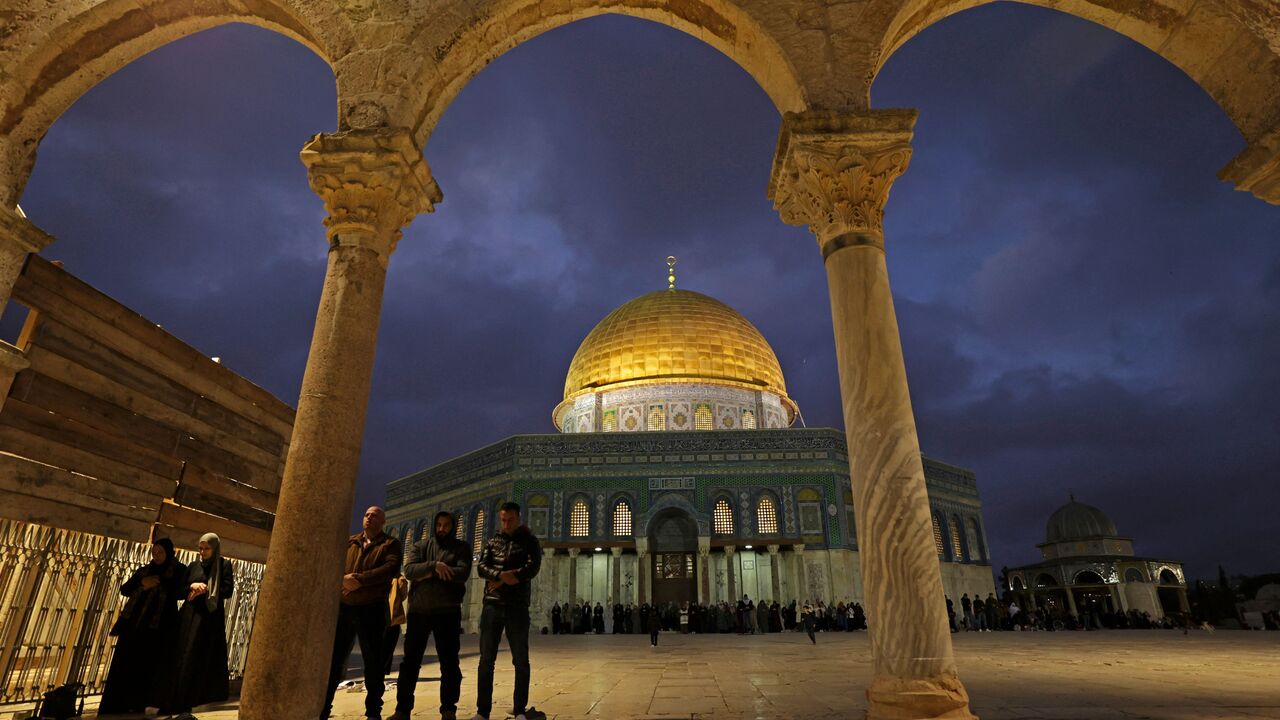 Palestinians pray outside the Dome of the Rock shrine at Al-Aqsa mosque compound, during the Muslim holy fasting month of Ramadan in Jerusalem on March 29, 2023. (Photo by HAZEM BADER / AFP) (Photo by HAZEM BADER/AFP via Getty Images)