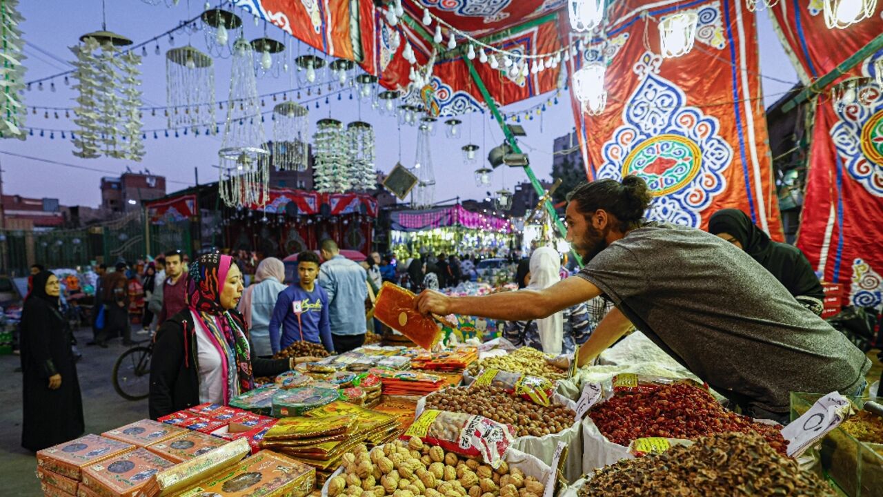 A vendor sells dates and dried fruits at a market in Cairo's central Sayyida Zeinab district