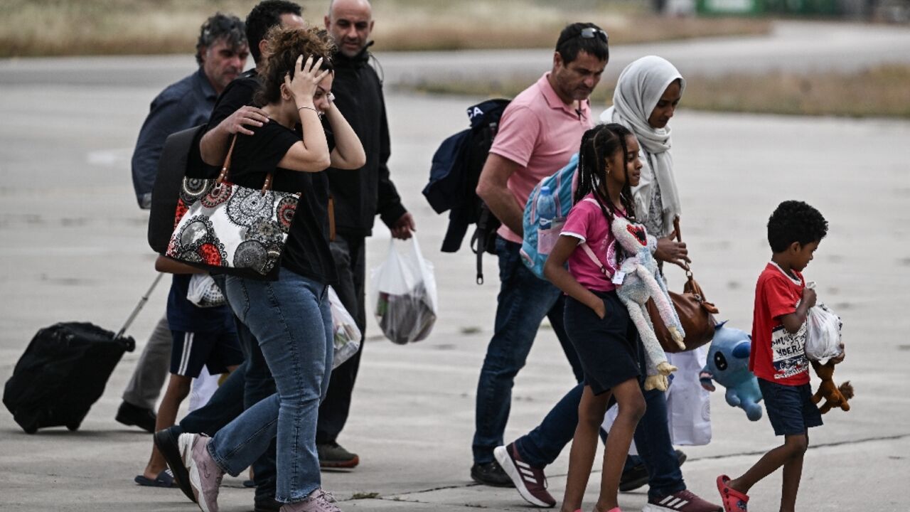 Greek nationals from Sudan arrive with a military C-27 plane at the military airport of Elefsina, south of Athens, on April 25, 2023