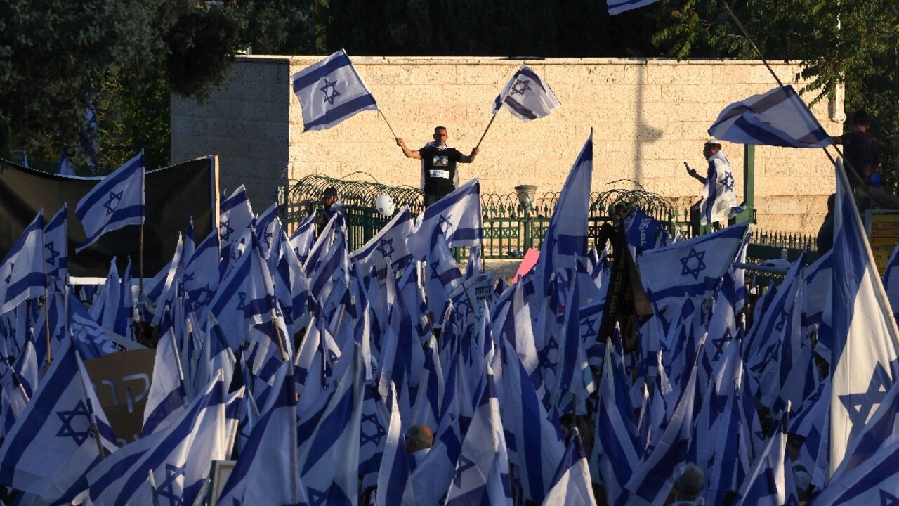 Pro-government protesters gather near Israel's parliament in Jerusalem on April 27, 2023 in support of the hard-right government's controversial push to overhaul the justice system 