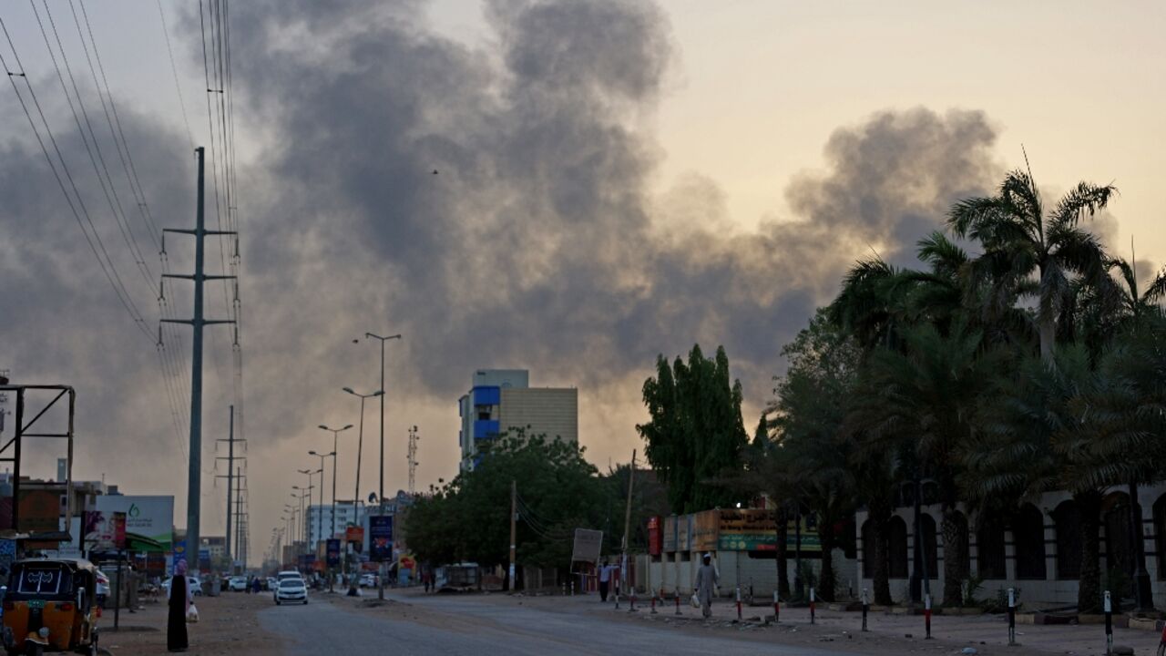 Smoke billows above residential buildings in east Khartoum as fighting in Sudan raged for a second day
