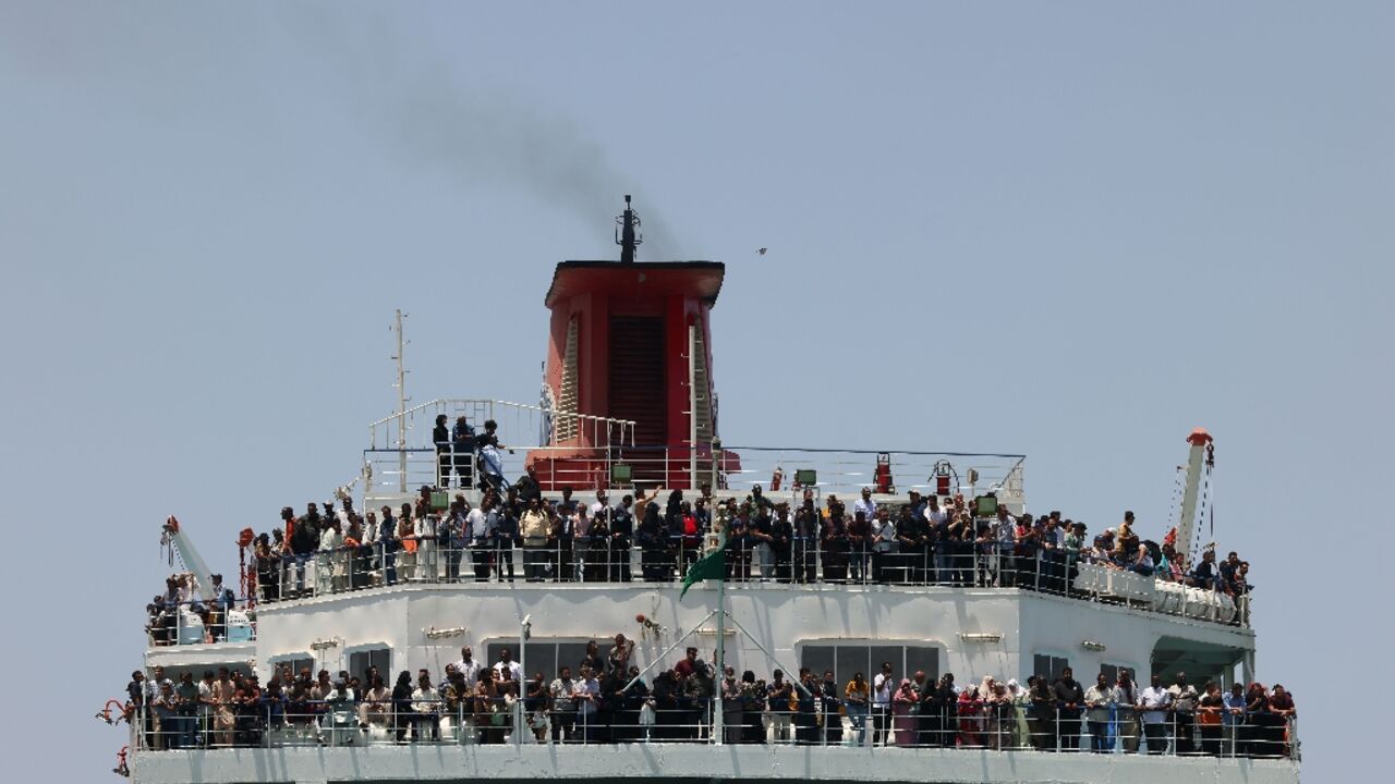 A ferry transporting about 1,900 people arrives at Saudi Arabia's King Faisal Naval base in Jeddah after crossing the Red Sea from Port Sudan with people who fled the fighting