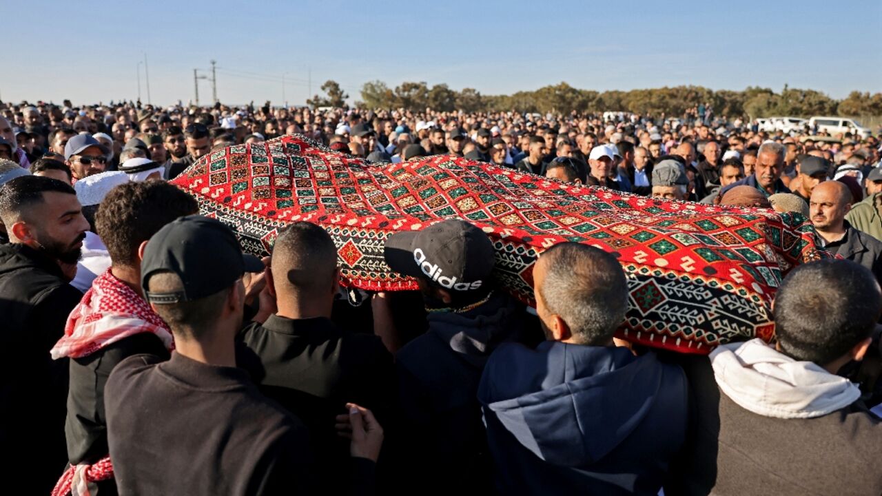 Mourners carry the body of Mohammed al-Asibi during his funeral in the southern Israeli Bedouin village of Hura 