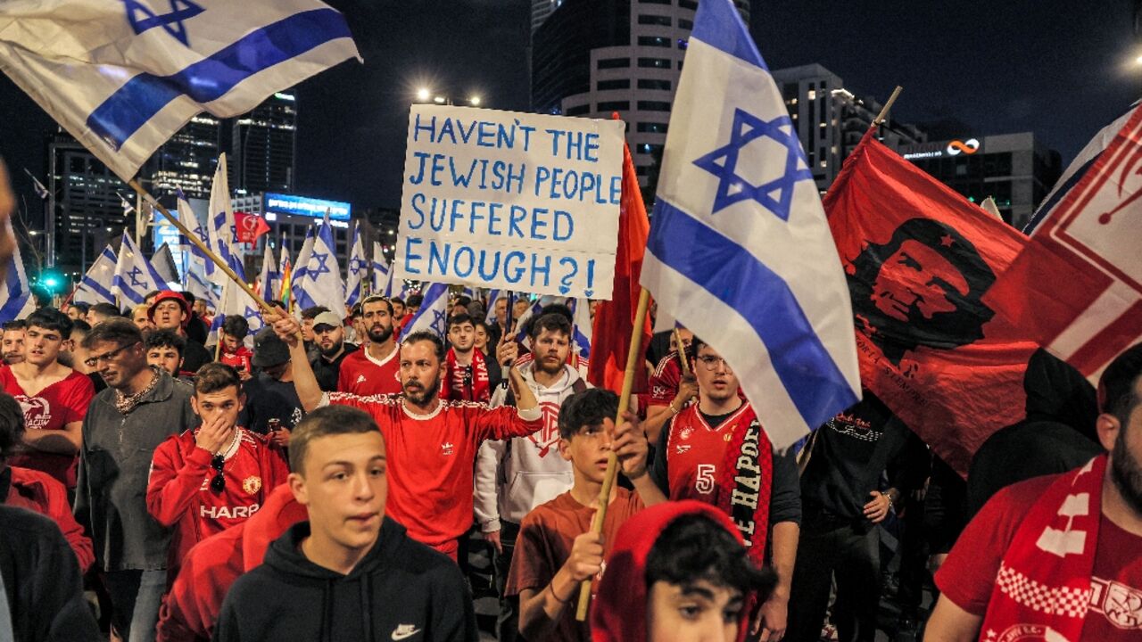Israelis march in Tel Aviv, keeping up their protests for a 13th straight week even after the hard-right government paused its controversial judicial reforms