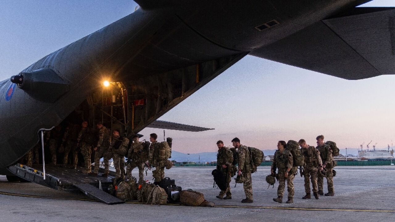 British Royal Marines board a C-130 Hercules aircraft at RAF Akrotiri in Cyprus, bound for Sudan to help in the evacuation of UK nationals