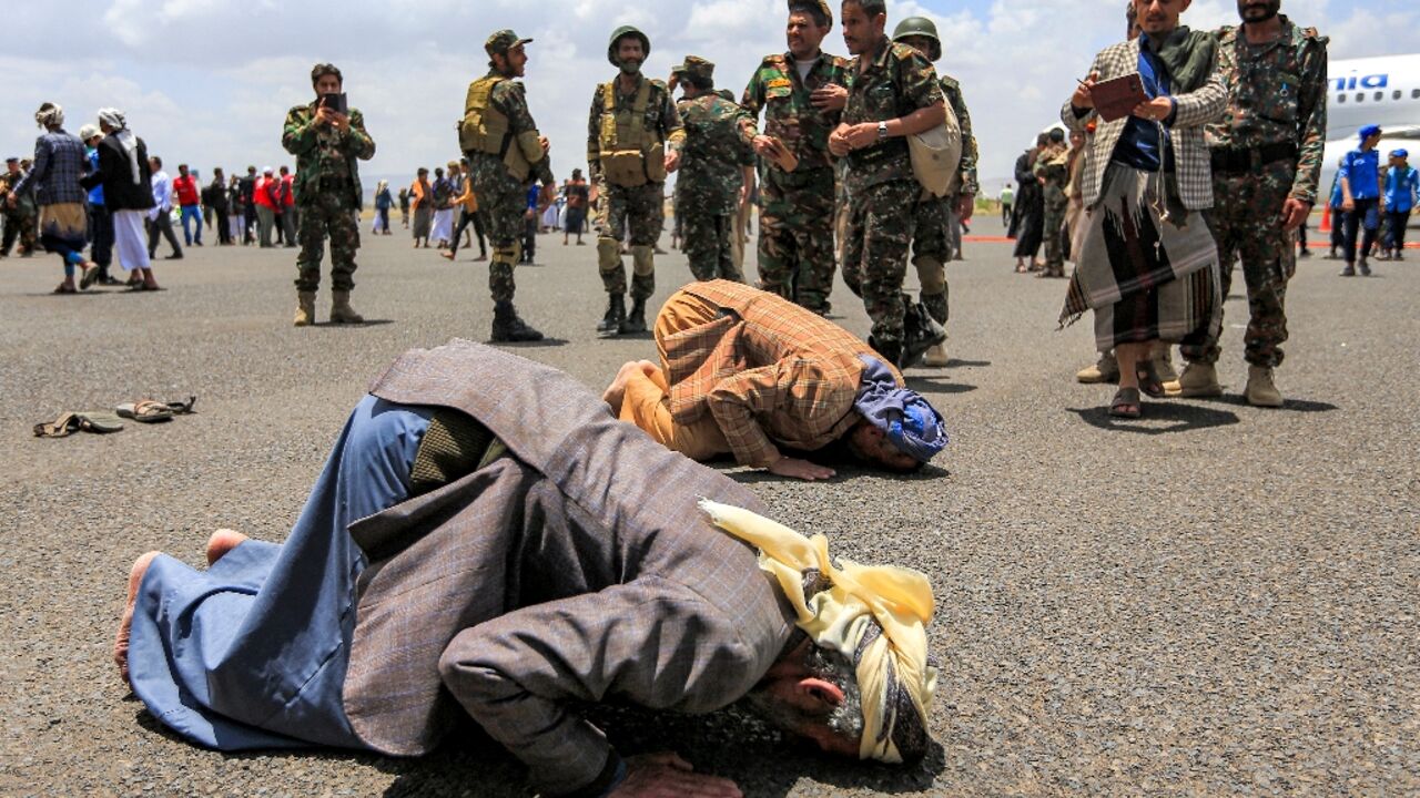 Released prisoners prayed on the tarmac at Sanaa airport