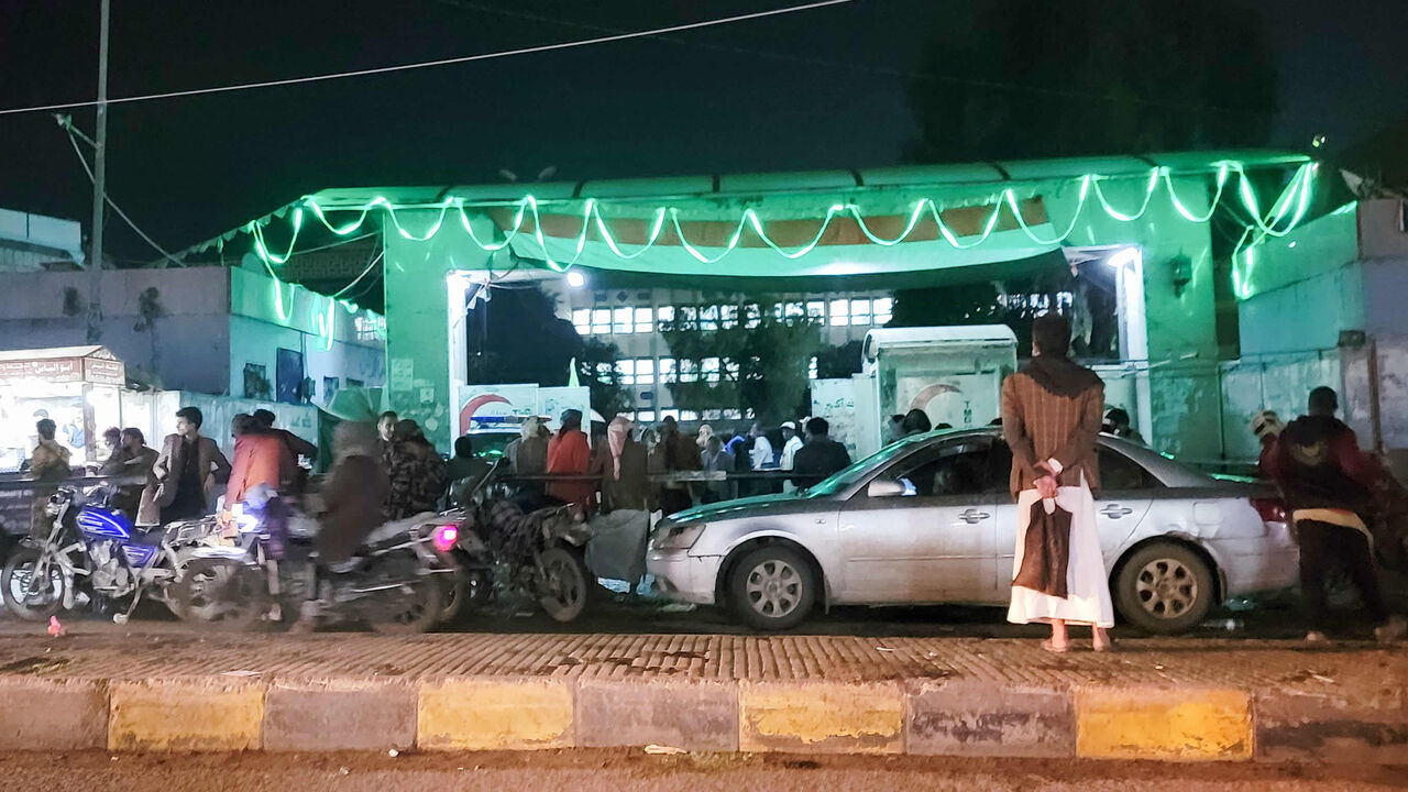 Yemenis wait outside a hospital after a stampede during charity distribution left at least 85 people dead and over 300 injured, Sanaa, Yemen, early April 20, 2023.