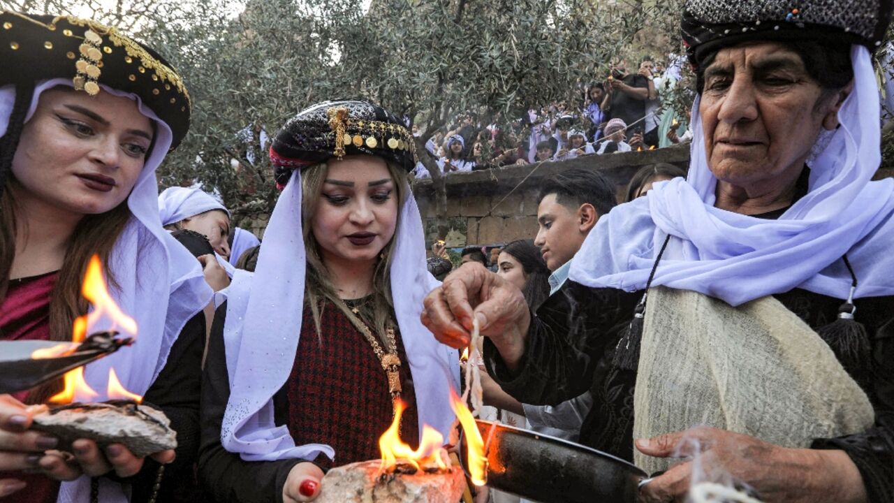 Members of Iraq's Yazidi minority celebrate New Year at a holy shrine in northern Iraq