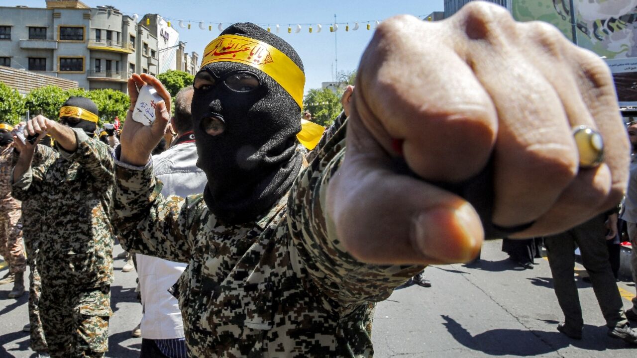 Members of Iran's Basij paramilitary forces perform poses during a rally marking Jerusalem Day