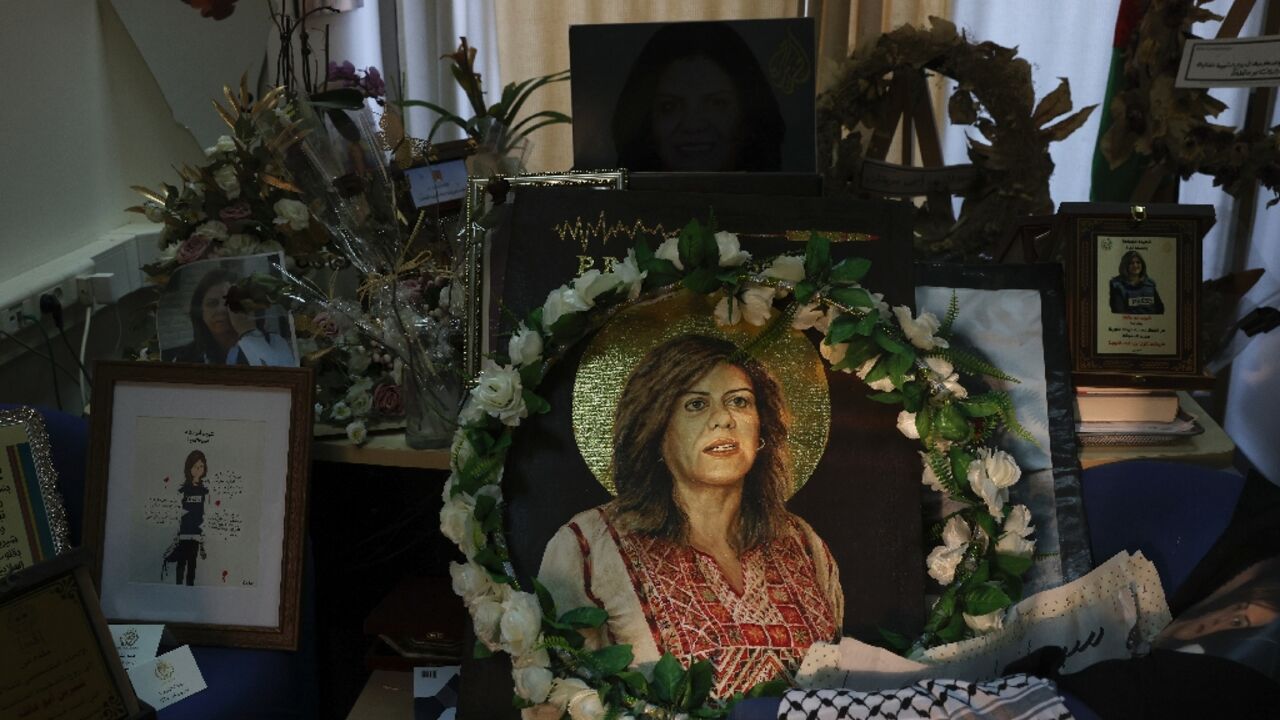 Pictures and other objects are displayed in memory of slain journalist Shireen Abu Akleh in the room that used to be her office at Al Jazeera in the West Bank city of Ramallah