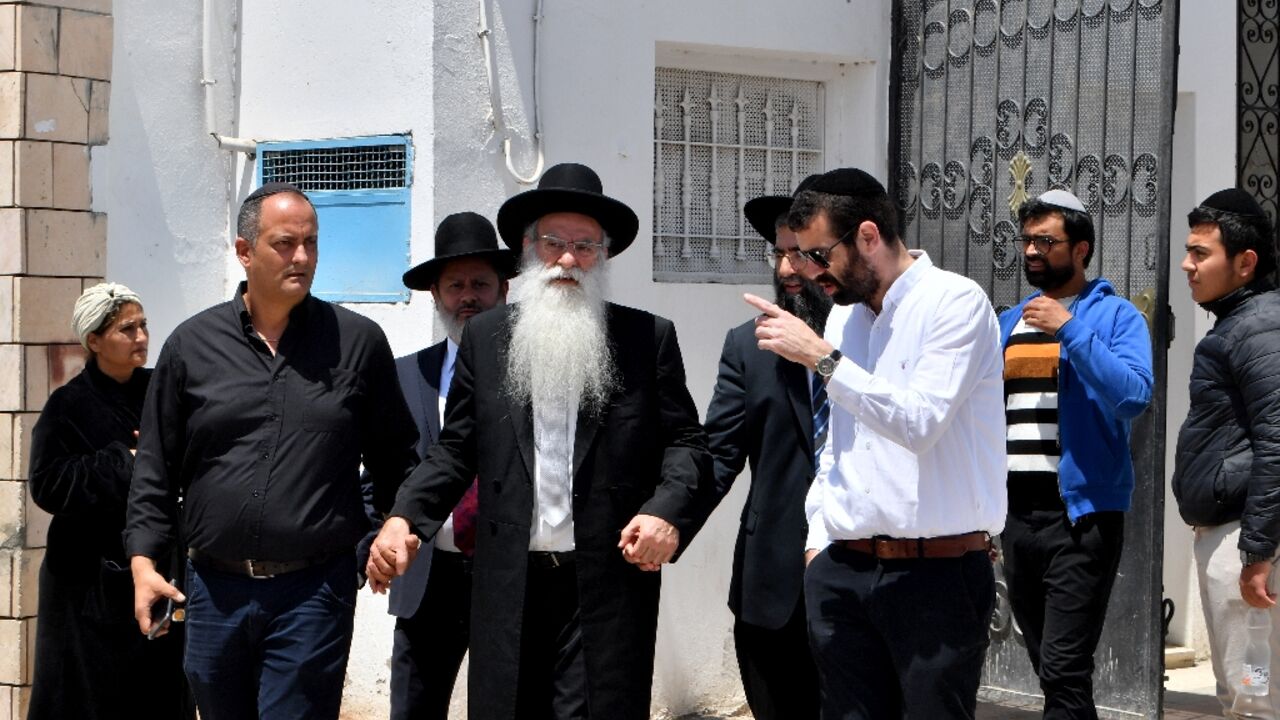 Members of the Jewish community in Hara Kebira, the main Jewish quarter of the resort island of Djerba, near the Ghriba synagogue following Tuesday's shooting spree