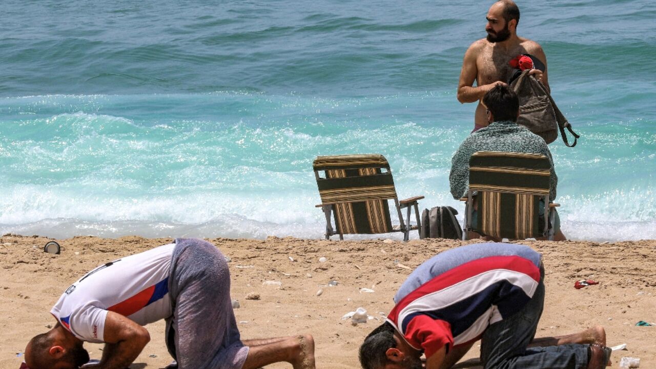 A group of conservative Muslims held prayers at the beach in Sidon as security forces deployed to the area