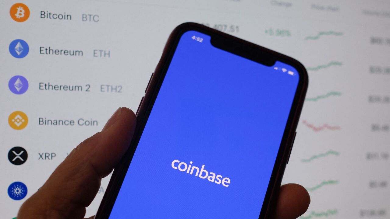 This illustration photo shows the Coinbase logo on a smartphone in Los Angeles on April 13, 2021. 