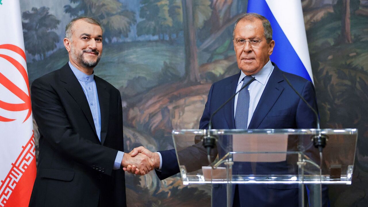 Russian Foreign Minister Sergei Lavrov (R) and Iranian Foreign Minister Hossein Amir-Abdollahian shake hands during a joint news conference as part of their meeting in Moscow, on Aug. 31, 2022. 