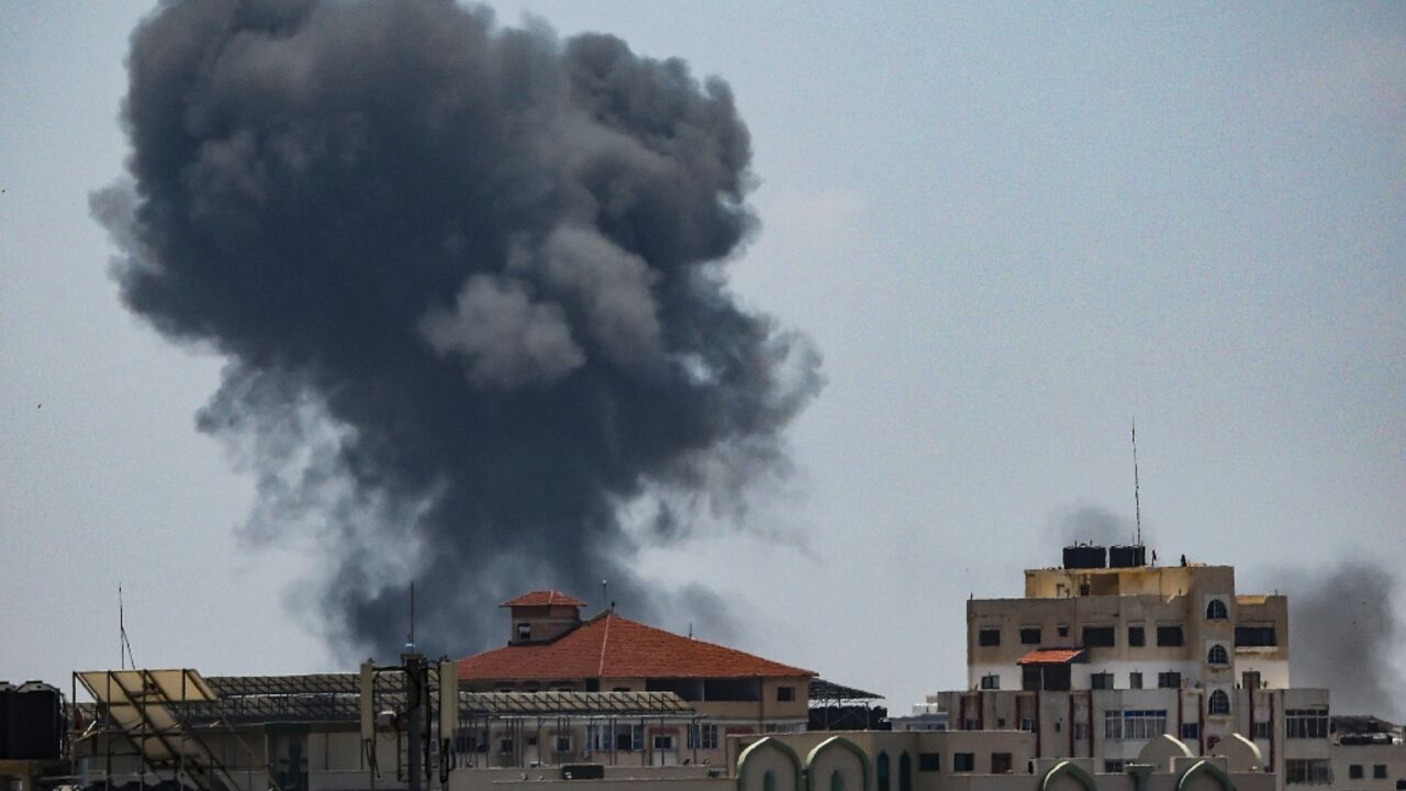 Smoke rises above buildings in Gaza City after during an Israeli air strike on May 13