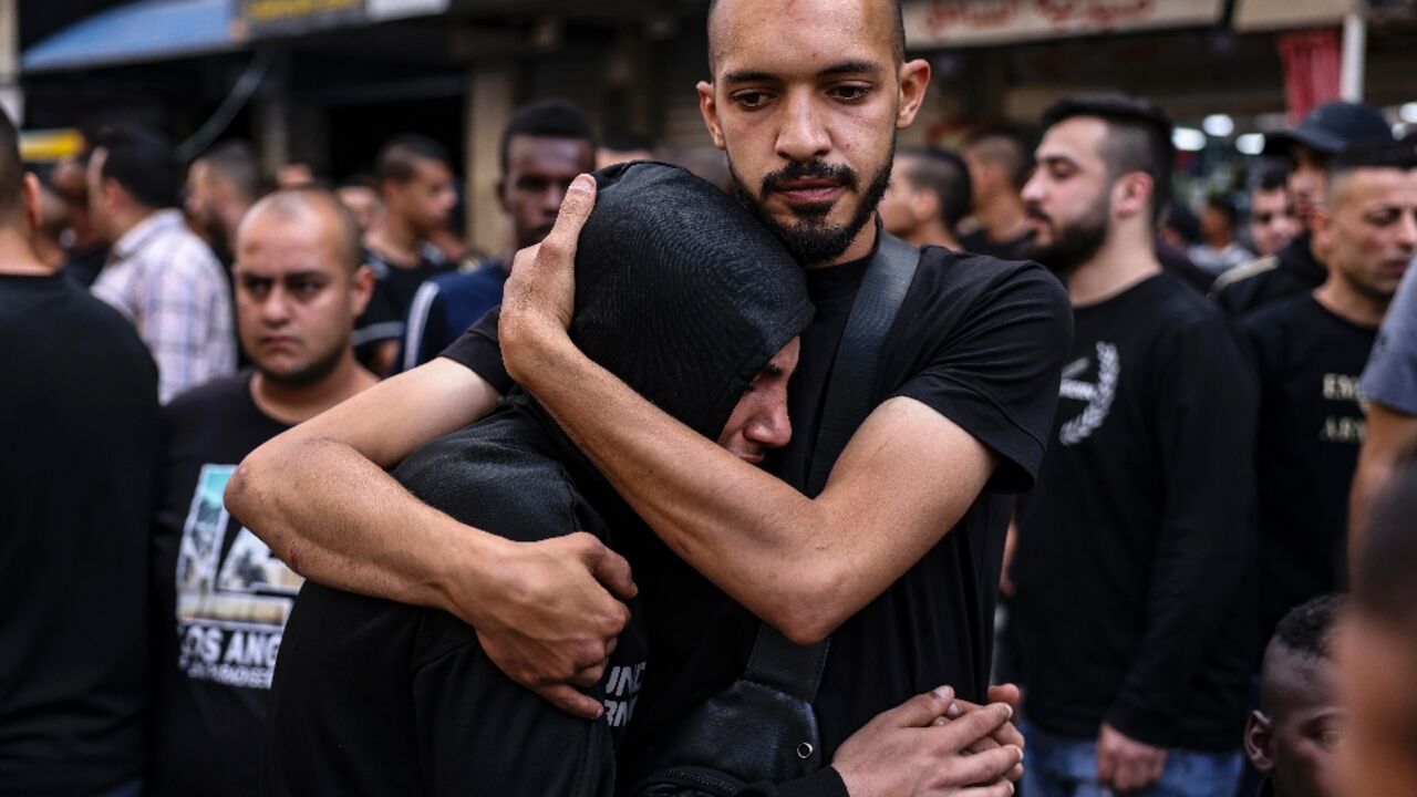 People mourn the death of two Palestinians killed by Israeli troops in a morning raid on Tulkarm in the occupied West Bank
