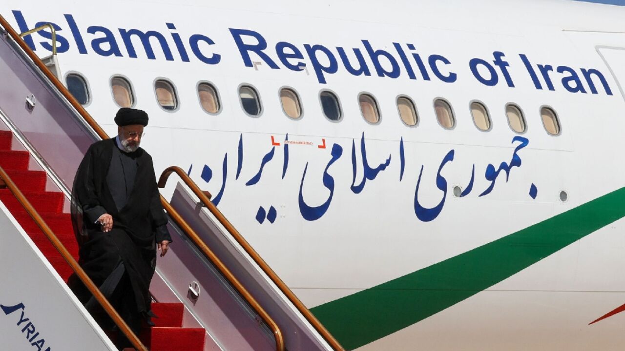 Iranian President Ebrahim Raisi leaving his plane after landing at Damascus International Airport on May 3, 2023