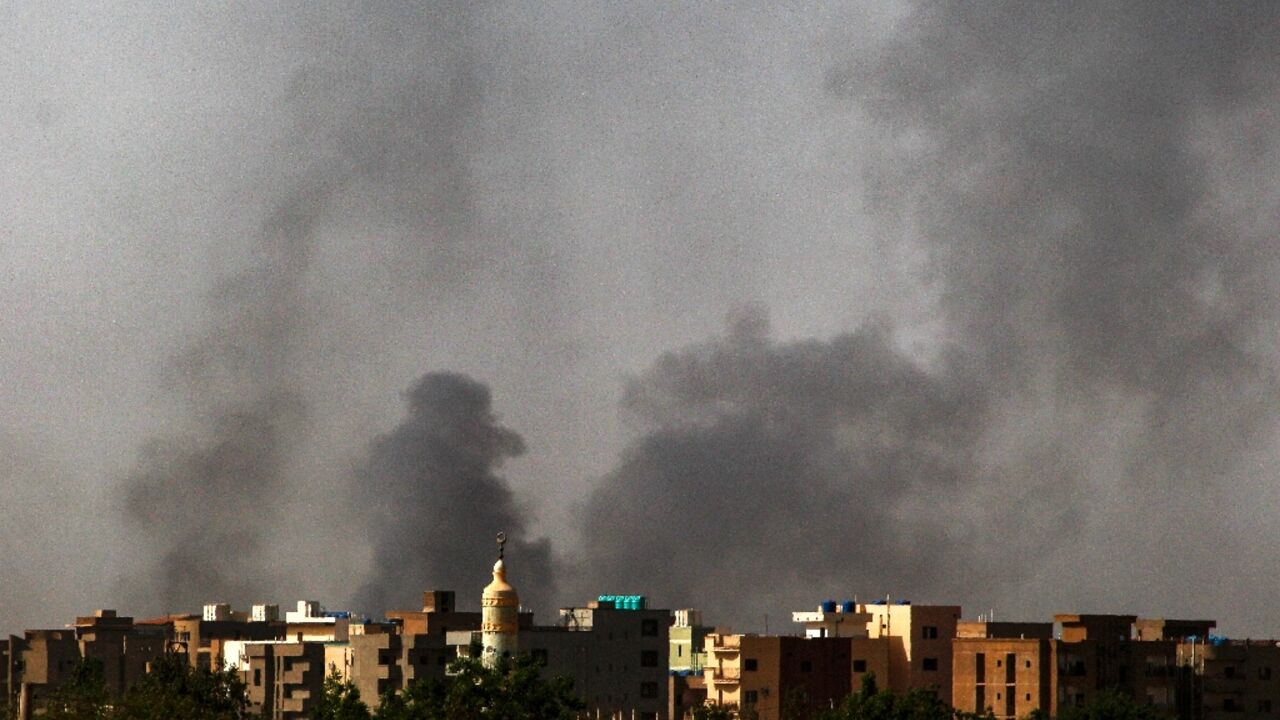 Smoke rises above buildings in Khartoum on the second day of the US- Saudi-brokered ceasefire as sporadic fighting continued