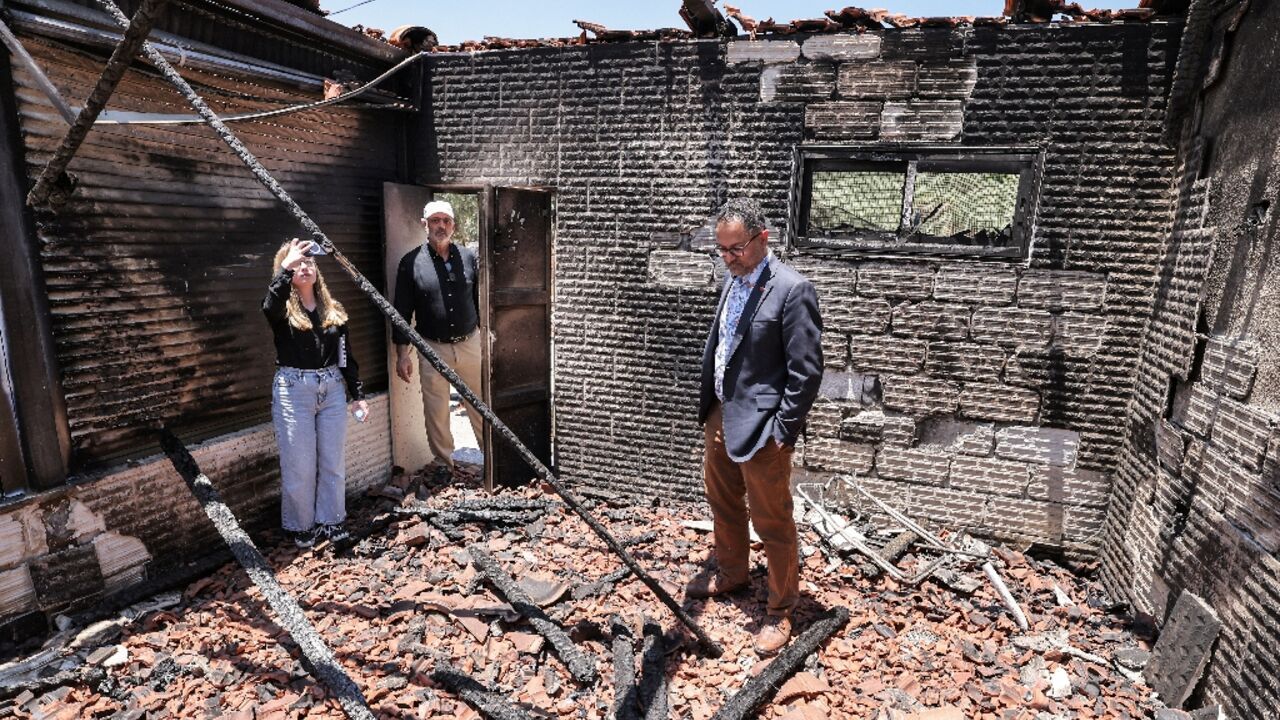 Foreign diplomats inspect the damage done to Palestinian homes in an arson spree by Jewish settlers in the West Bank village of Turmus Ayya earlier this week