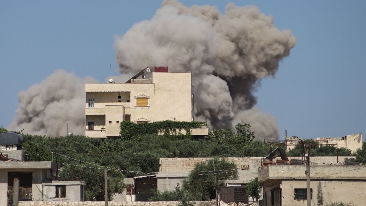 A plume of smoke rises from a building following a reported Russian air strike on Syria's northwestern rebel-held Idlib province, on June 25, 2023