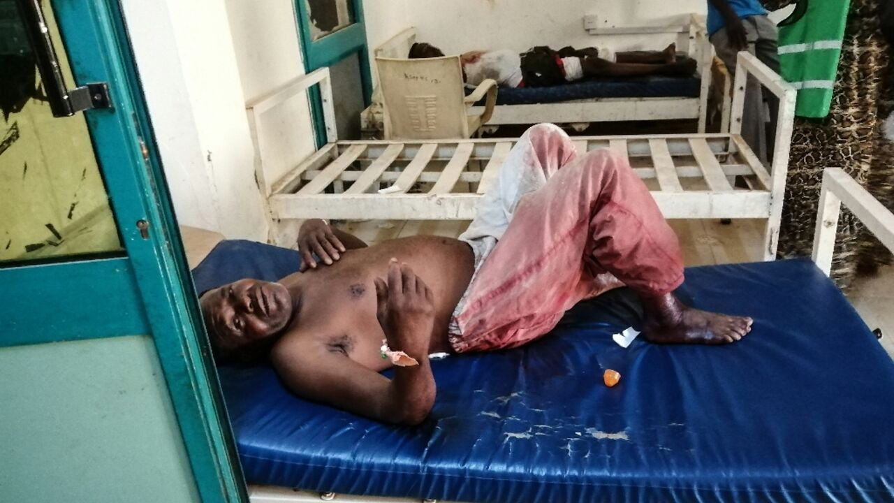 A wounded man rests on a hospital bed at al-Bashayer hospital in northern Khartoum -- most health facilities in Sudan's main battlegrounds are out of service