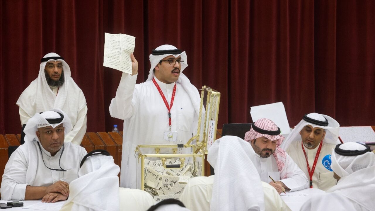 A Kuwaiti judge and his aides count the ballots at a polling station for parliamentary elections on Kuwait City