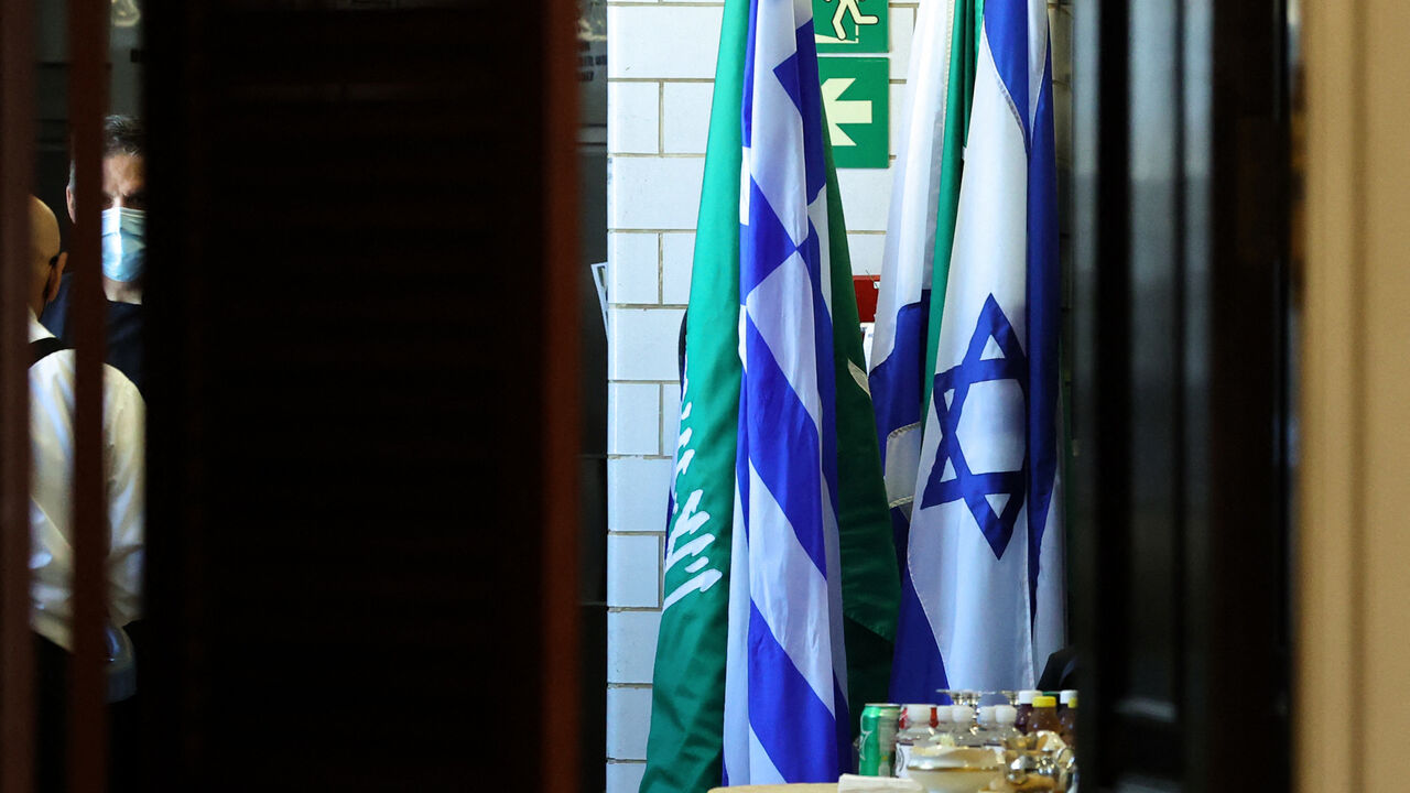 Flags of Saudi Arabia and Israel stand together in a kitchen staging area as US Secretary of State Antony Blinken holds meetings at the State Department in Washington, DC, October 14, 2021. (Photo by JONATHAN ERNST / POOL / AFP) (Photo by JONATHAN ERNST/POOL/AFP via Getty Images)