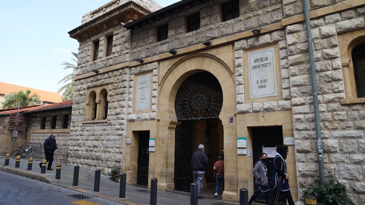 People walk past the main gate to the campus of the American University of Beirut (AUB) in the heart of the Lebanese capital, on January 13, 2022. - Power shortages and soaring petrol prices mean many Lebanese students can neither afford to reach their classes nor study from home, a conundrum that is ravaging a generation's future. (Photo by ANWAR AMRO / AFP) (Photo by ANWAR AMRO/AFP via Getty Images)