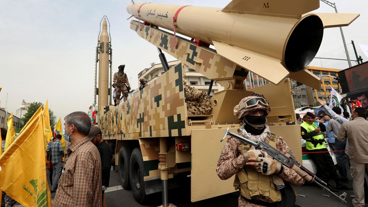 Iranian soldiers stand next to an Iranian Kheibar missile (R) and a Shahab-3 missile (L) during a rally marking al-Quds (Jerusalem) day, in street at the capital Tehran, on April 29, 2022. - An initiative started by the late Iranian revolutionary leader Ayatollah Ruhollah Khomeini, Quds Day is held annually on the last Friday of the Muslim fasting month of Ramadan. (Photo by AFP) (Photo by -/AFP via Getty Images)