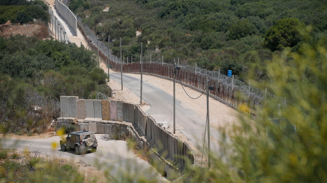 Israeli military vehicles patrol the border with Lebanon near the Israeli Kibbutz of Shtula, July 3, 2022.