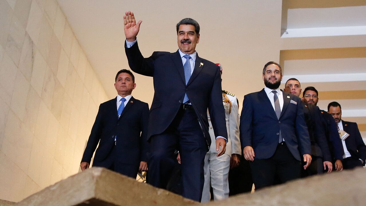 Venezuela's President Nicolas Maduro waves as he leaves Itamaraty Palace in Brasilia on May 30, 2023, after a summit with other South American leaders. Brazilian President Luiz Inacio Lula da Silva is hosting his fellow South American leaders Tuesday for a "retreat" aimed at strengthening ties in a region where left-wing governments are newly back in style. (Photo by Sergio Lima / AFP) (Photo by SERGIO LIMA/AFP via Getty Images)